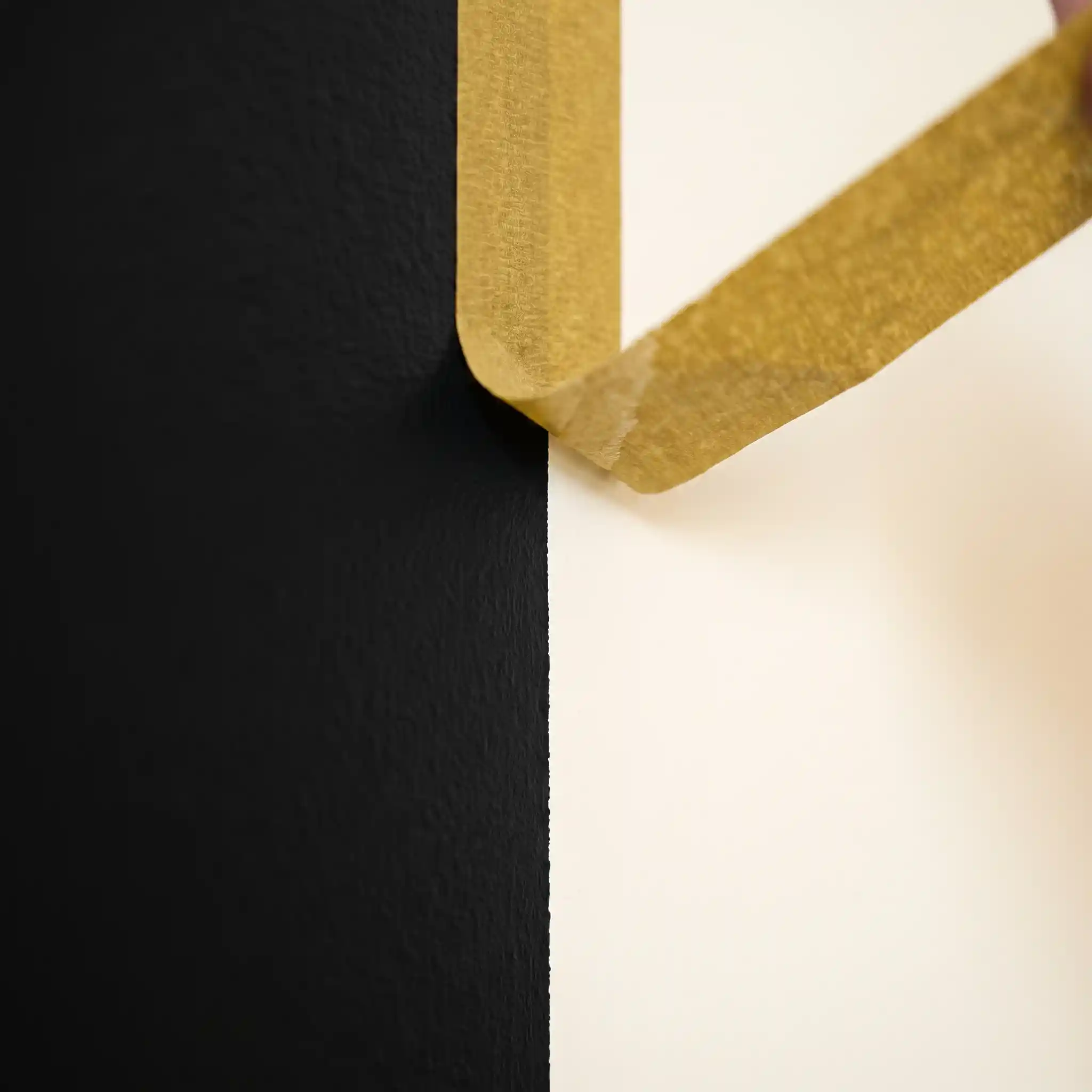 Painter's tape pulled back to reveal a perfect clean edge